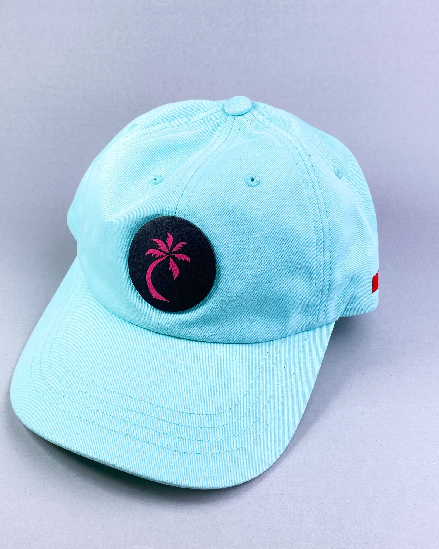 Bravo Cay hat in teal with single palm design leather patch