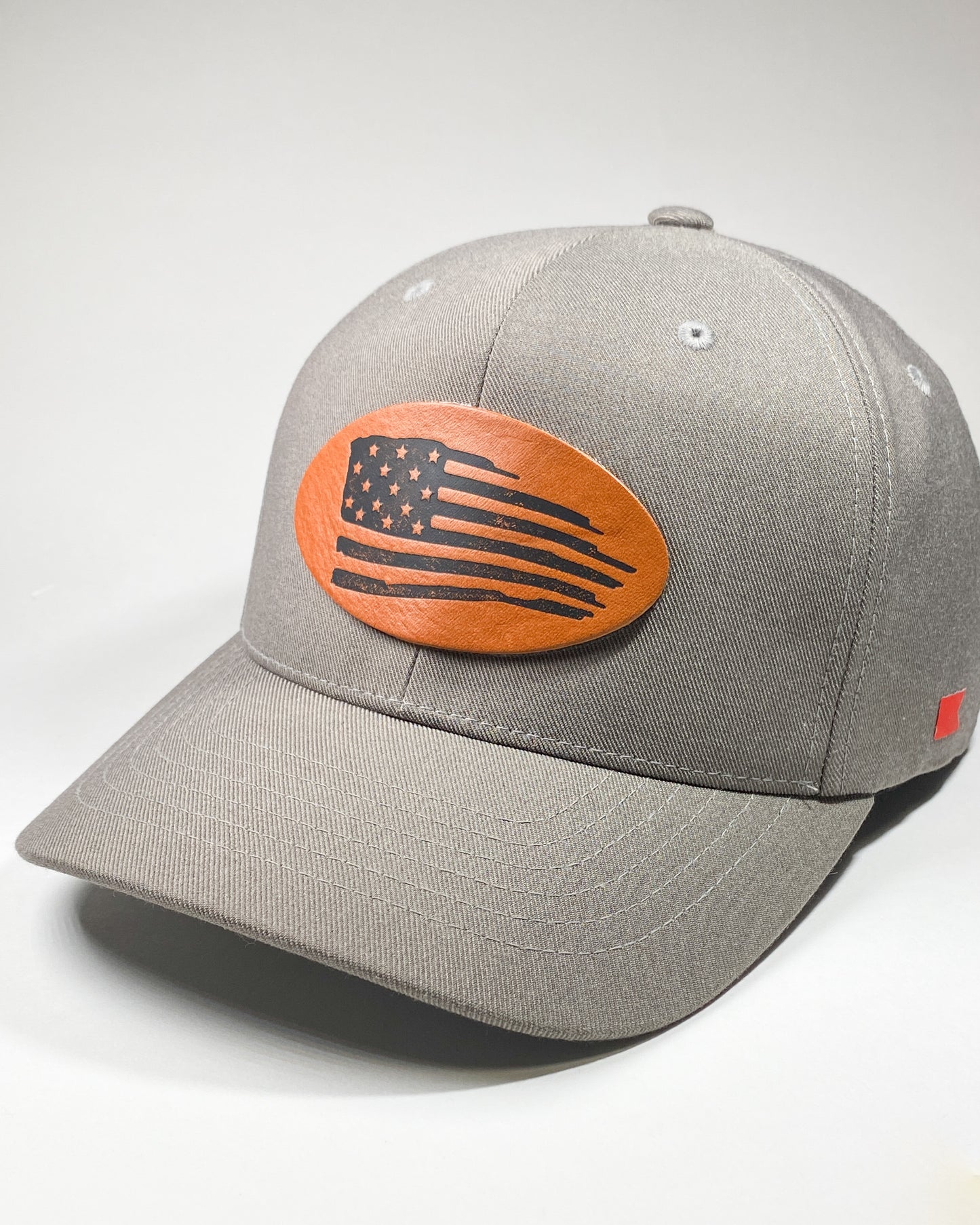 Bravo Cay hat in grey with distressed flag design leather patch