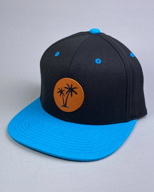 Bravo Cay hat in turquoise/black with two palm design leather patch
