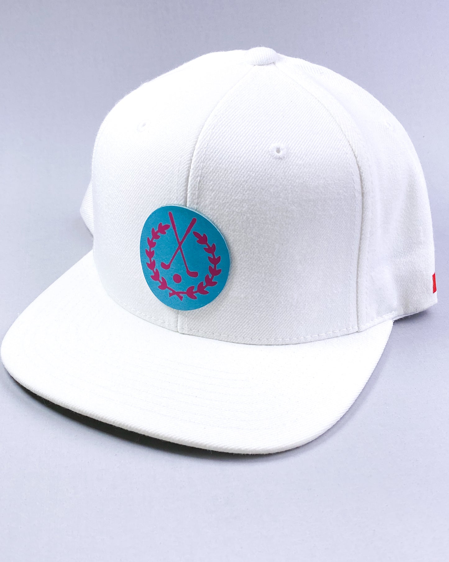 Bravo Cay hat in white with golf themed design leather patch